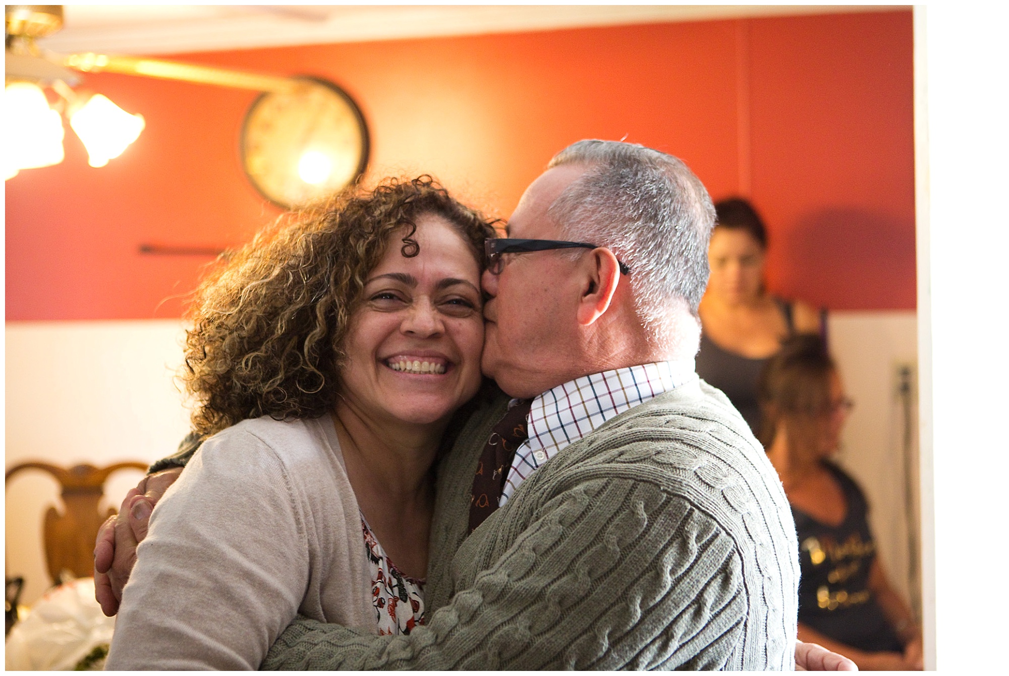 Photo of grandfather kissing mother of bride on the cheek 