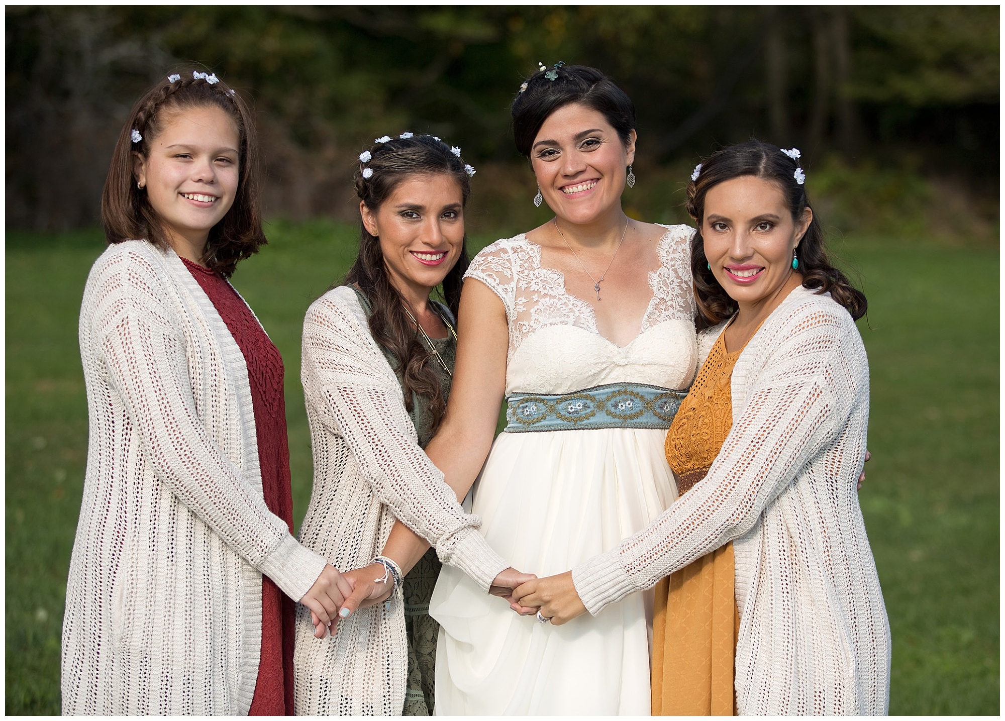 The bride and bridesmaids holding hands in this group portrait