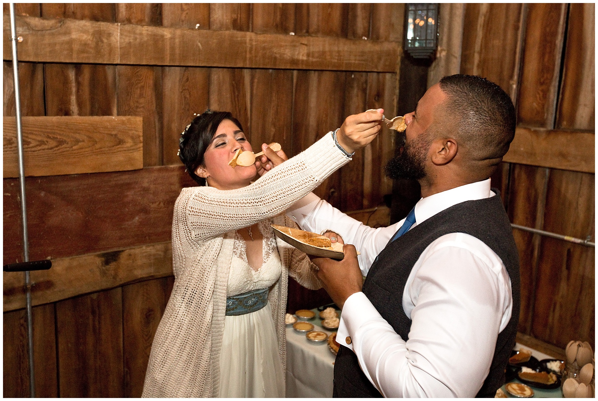 Bride and groom feeding each other pie rather than the traditional wedding cake.