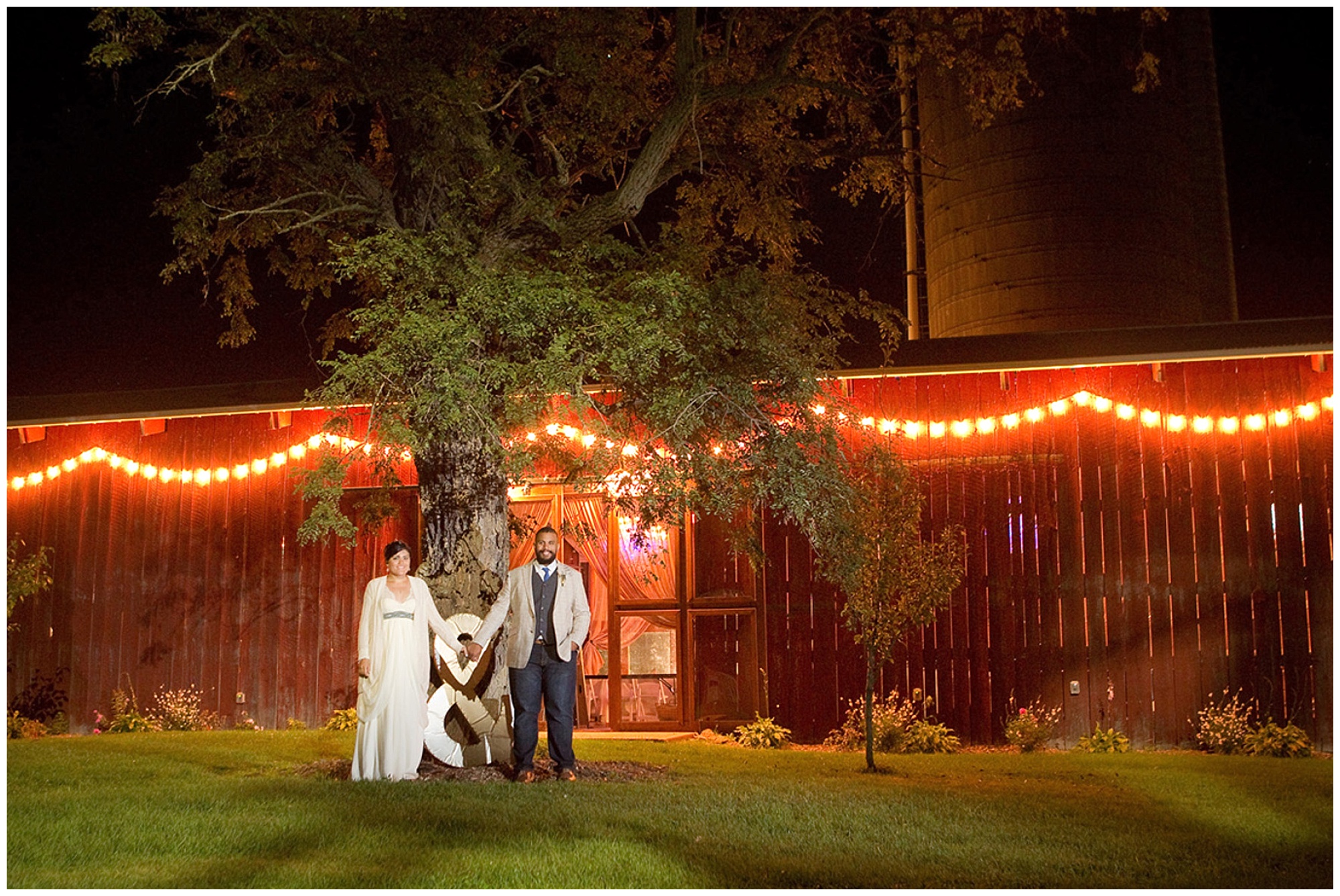 Bride and groom in this night photo outside the reception barn.