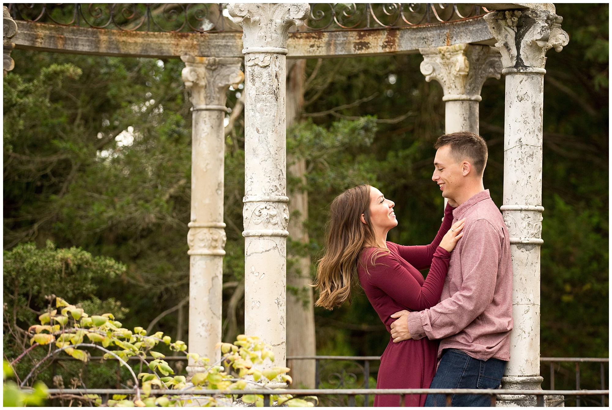Photo of an engaged couple looking into eachother's eyes while under a gazebo.