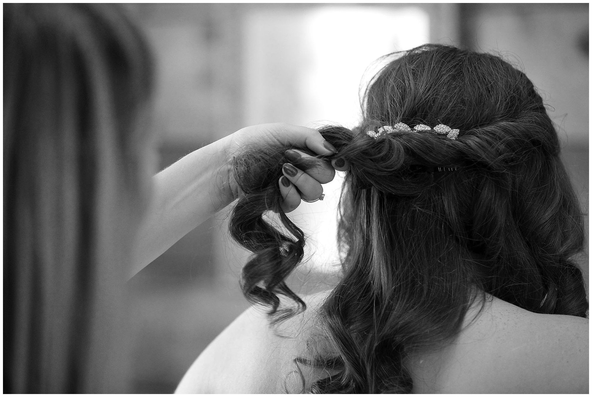 Photo of a bride getting her hair done.