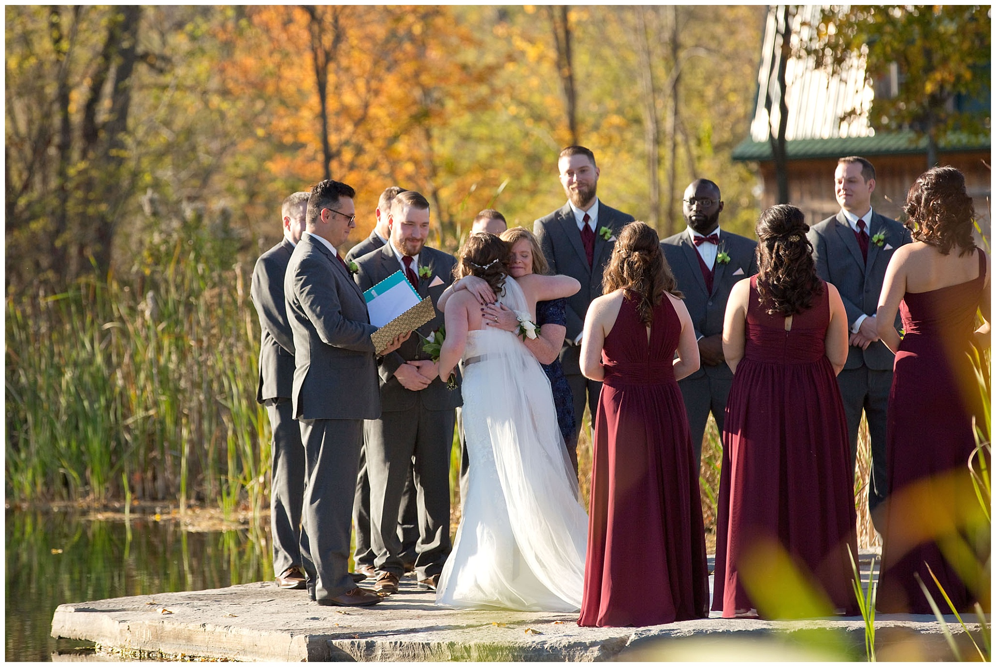 Photo of mother hugging her daughter bride after handing her off to her groom.