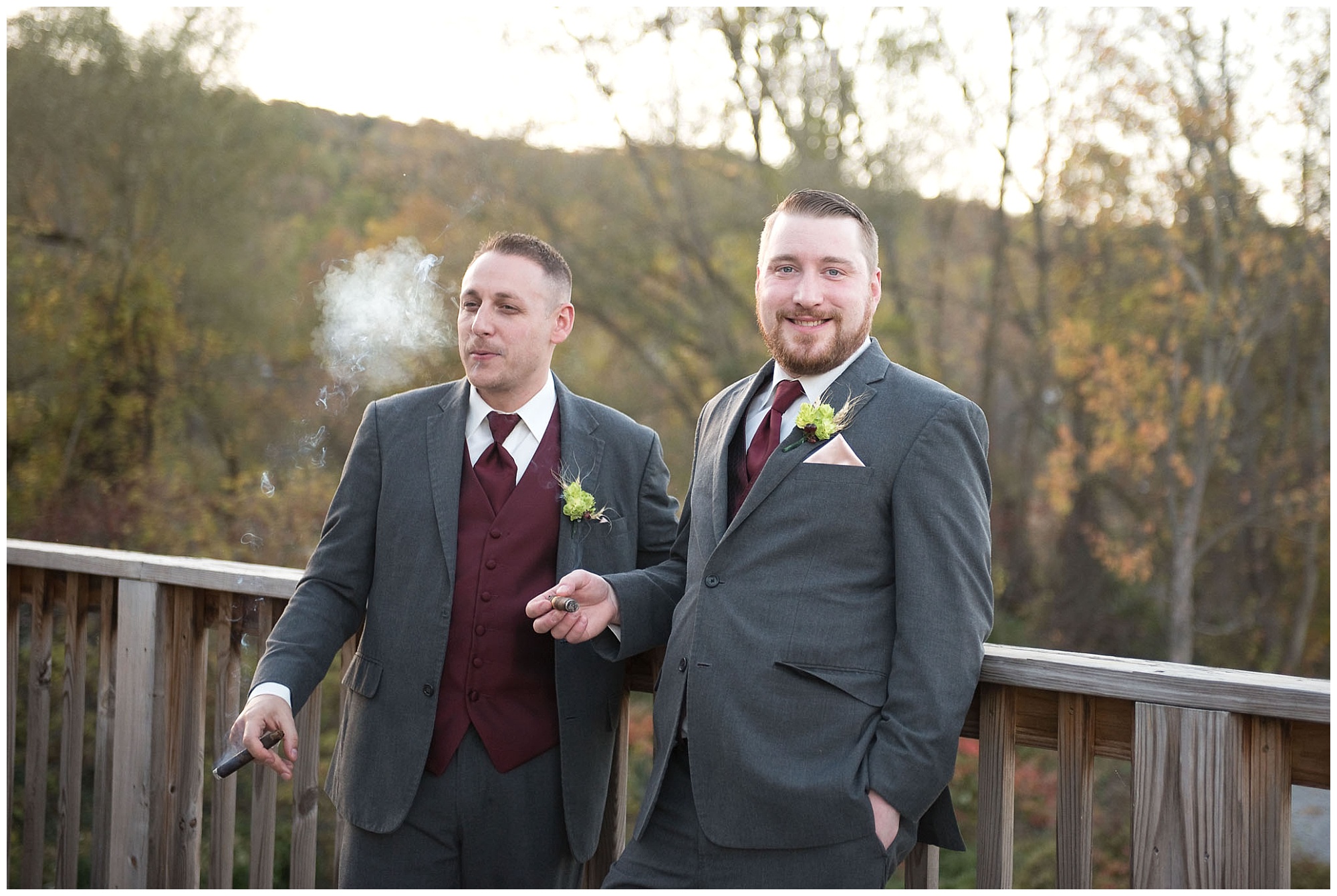 A groom smoking a cigar during coctail hour.