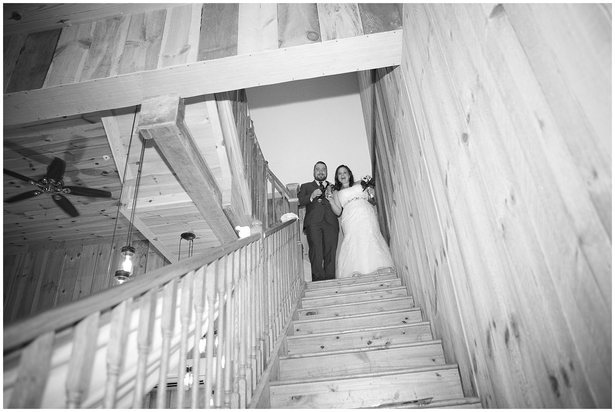 Bride and grrom atop the venue stairway awaiting thier introduction to the reception.