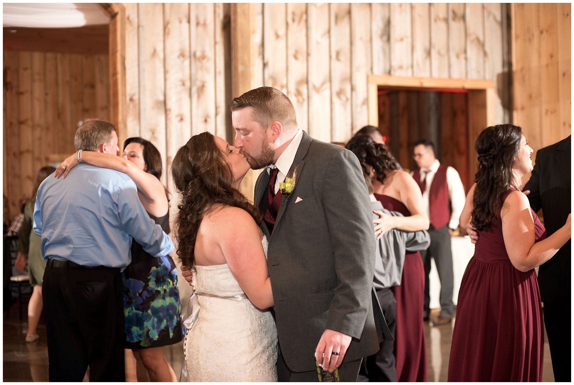 Photo of the bride and grrom kissing on the dance floor