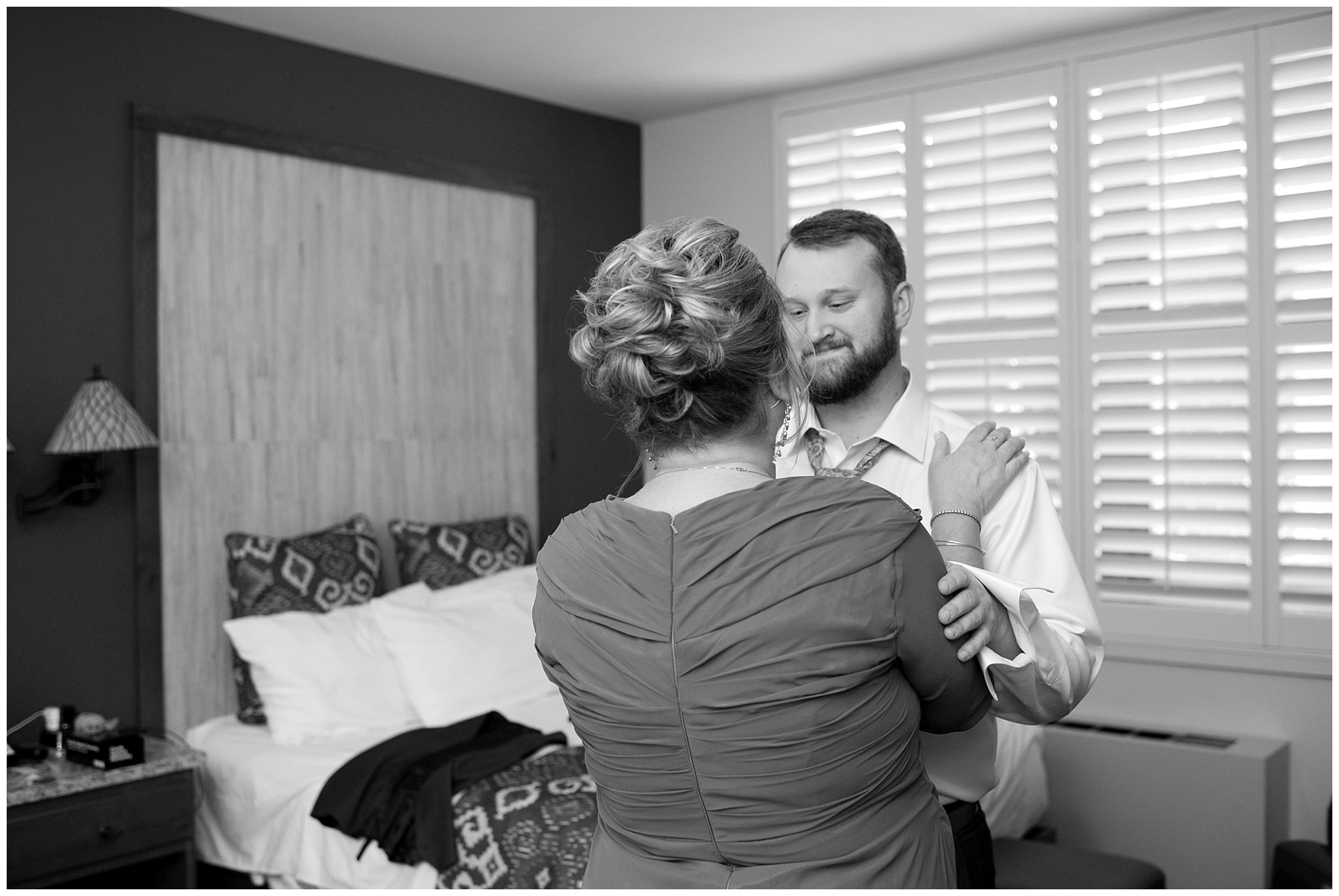 A photo of a groom and his mom caught in an emotion filled moment.