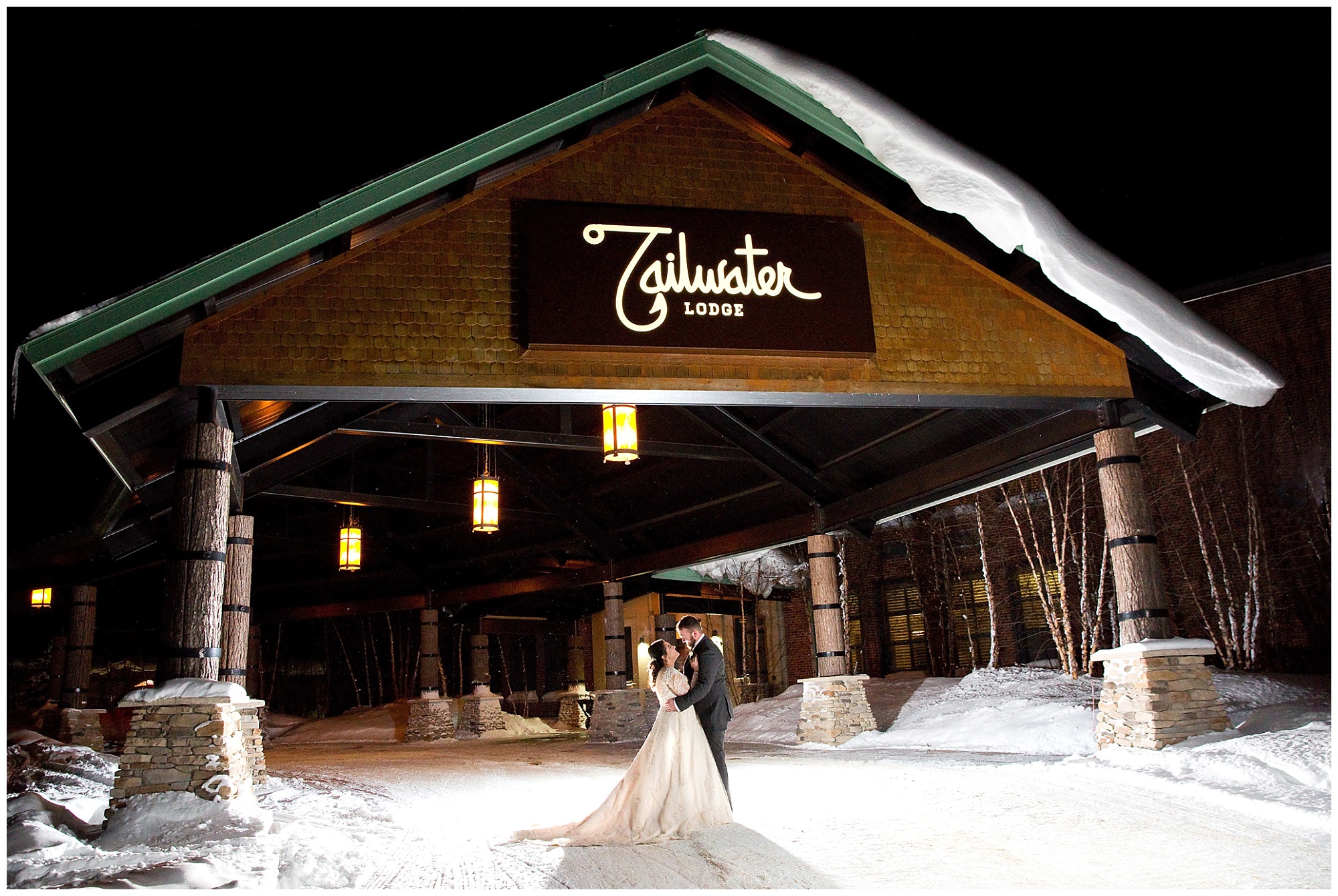 Photo of a bride and grrom in an embrace outside the Tailwater Lodge (Altmar, NY) entrance during a winter setting, 