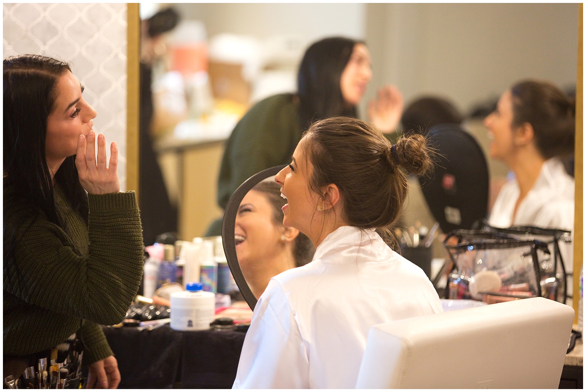 Photo of a laughing bride getting ready for her wedding.