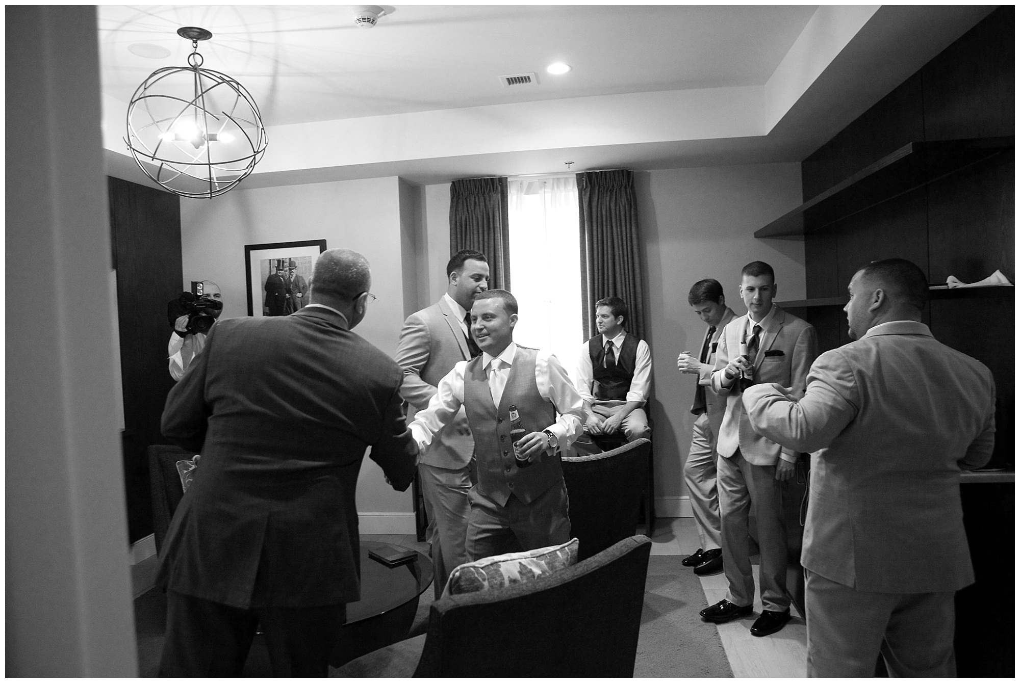 photo of a groom shaking the hand of his soon to be father in law.