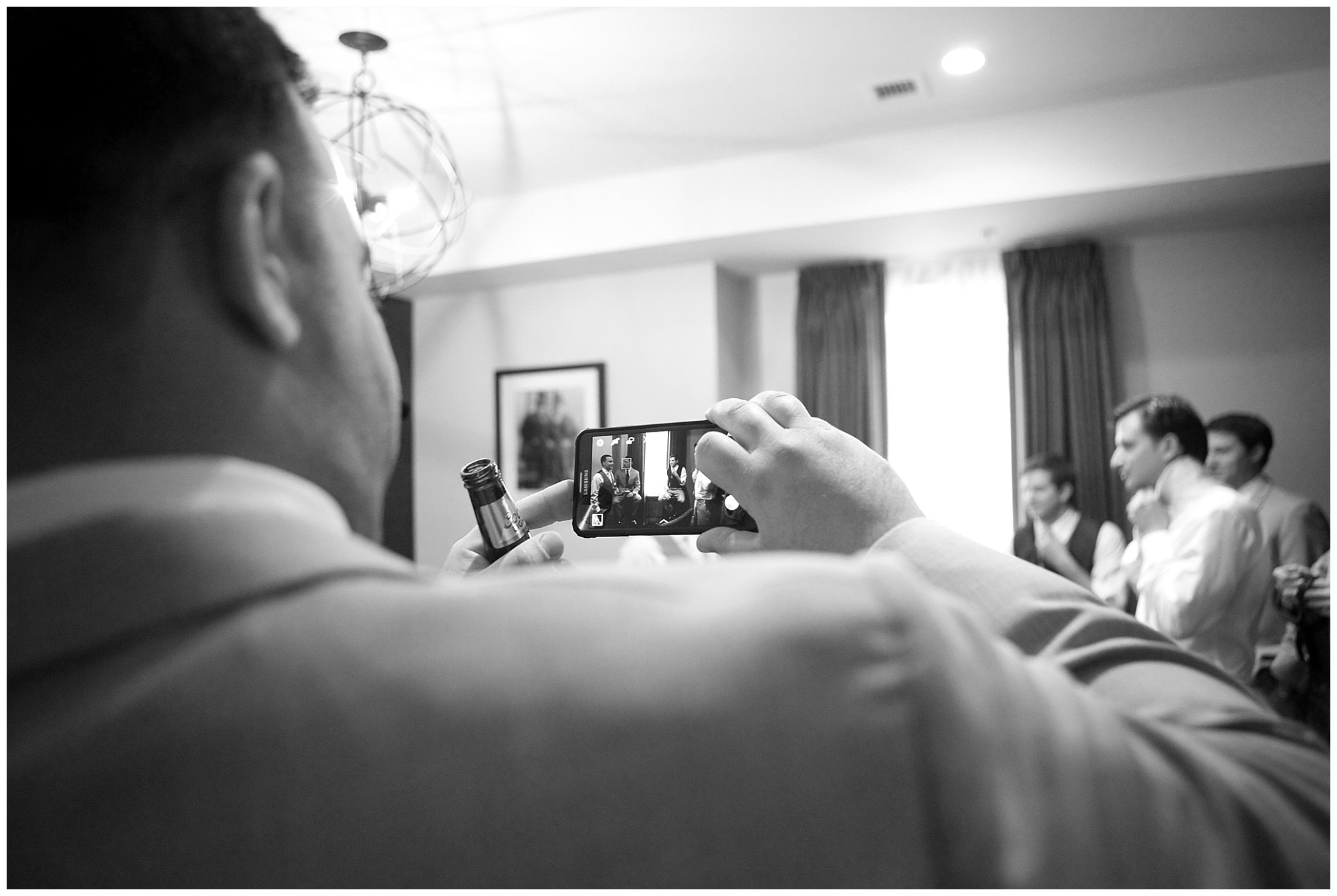 Photo of a groomsmen photographing his friends before a wedding.