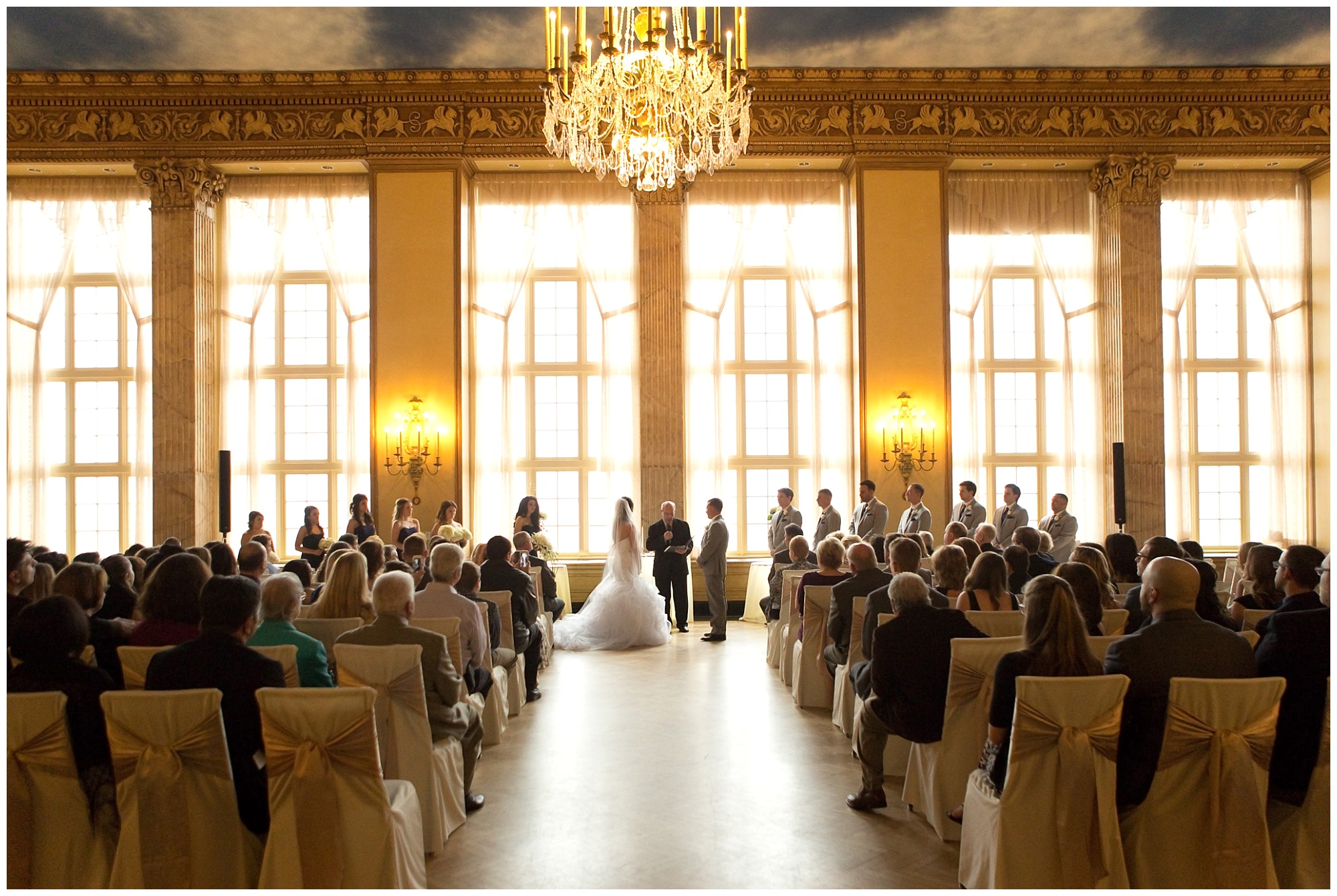 A wide angle photo of a wedding ceremony at teh Marriott Syracuse Downtown.